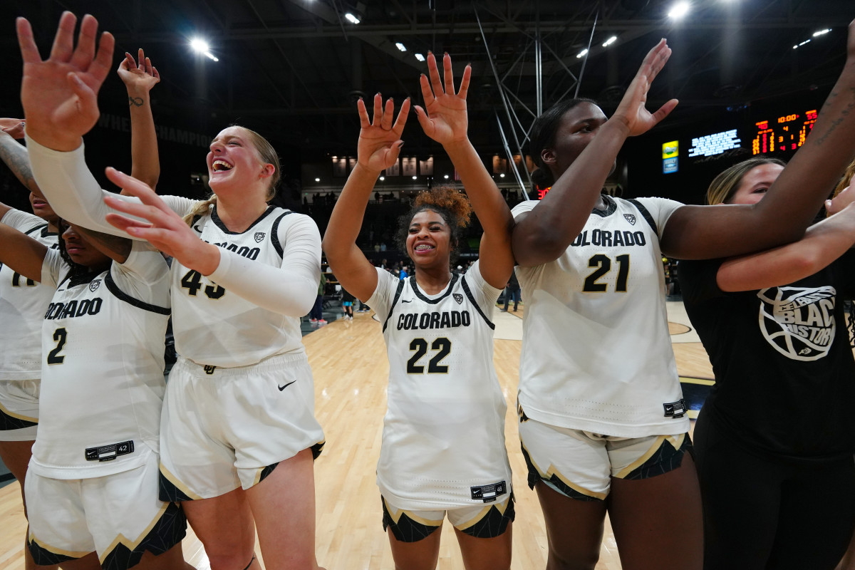 Colorado Buffaloes guard Tameiya Sadler (2) and forward Charlotte Whittaker (45) and guard Shelomi Sanders (22) and center Aaronette Vonleh (21) celebrate defeating the Oregon Ducks at CU Events Center